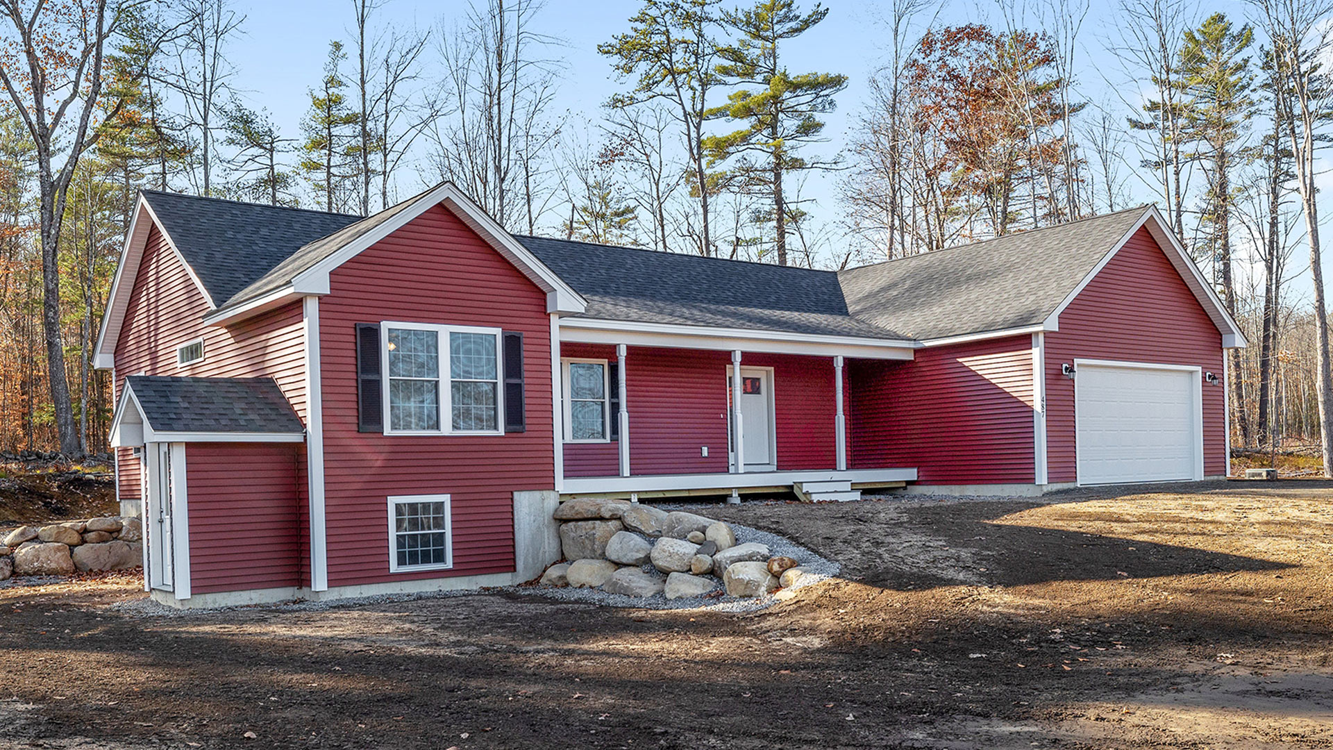 A red two-story house with lap siding. Red with white trim.